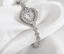 Load image into Gallery viewer, Heart-shaped rhinestone quartz watch with mother-of-pearl face, silver tone adjustable bracelet, vintage inspired design